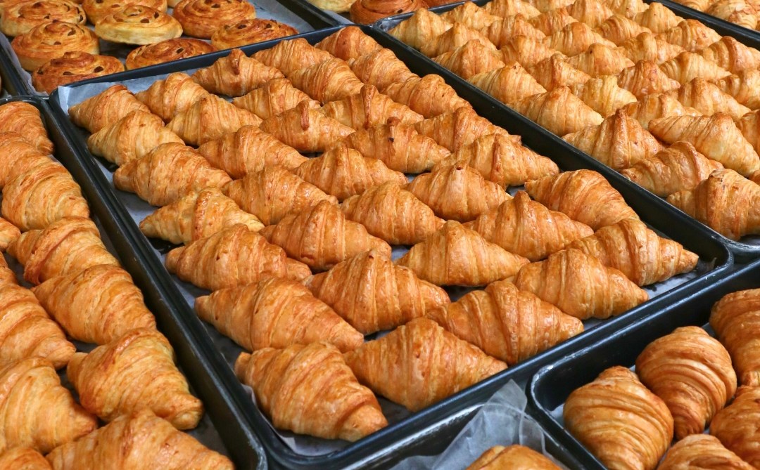 Trays of fresh croissants and pastries at TheCake Factory