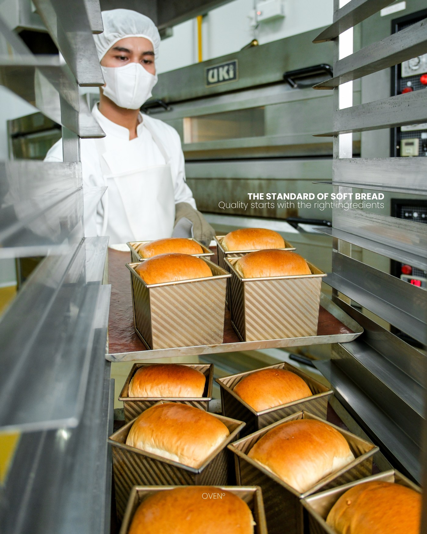 Baker beside racks of freshly baked shokupan