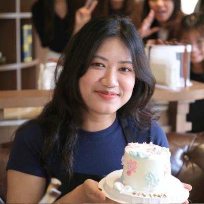 Student smiling with her finished cake