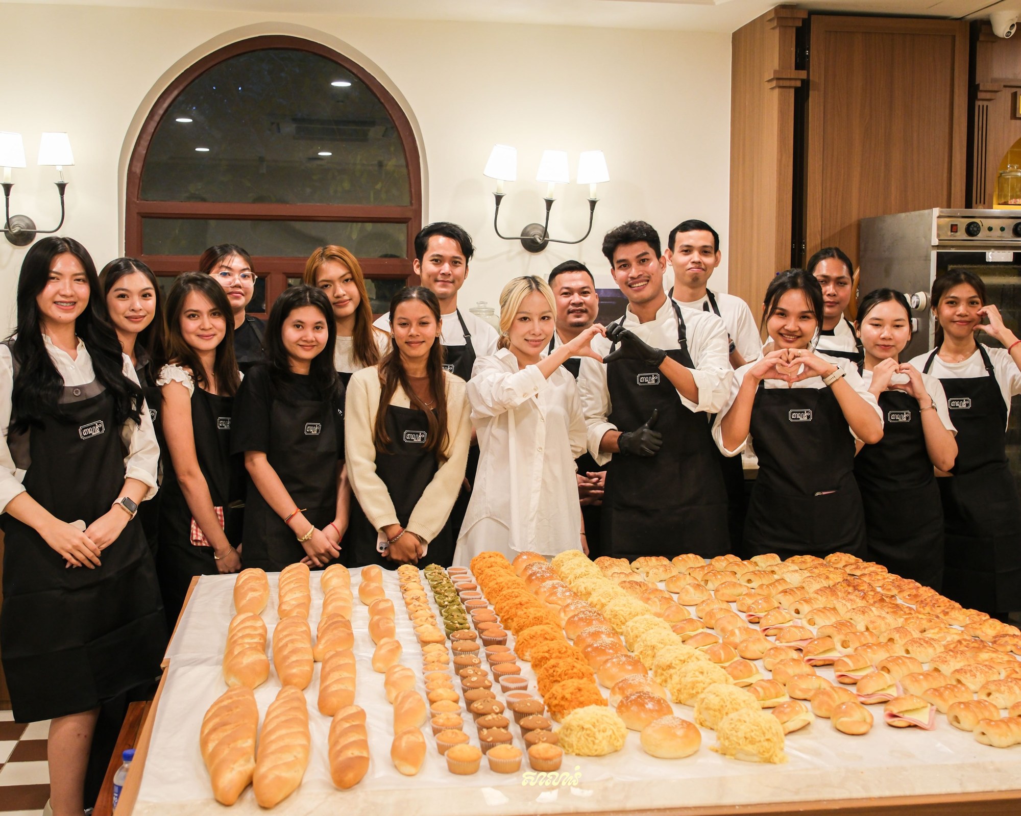 The Salanum team and students behind a table of fresh bread