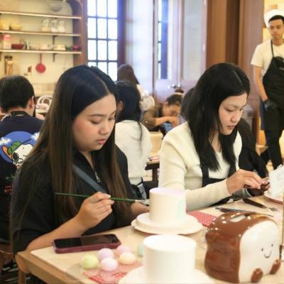 Students painting cakes in class